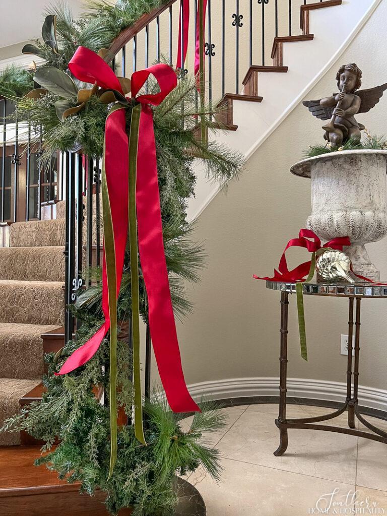 Red and green ribbon on staircase garland