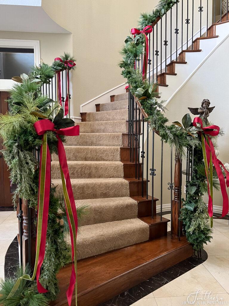 Faux garland on staircase with pine, cedar, and magnolia