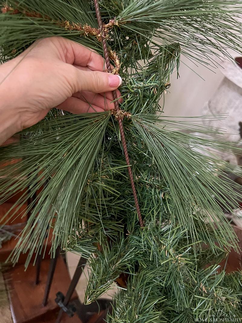 Adding pine pick to garland