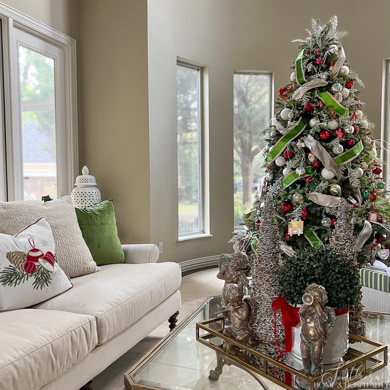Red, green, and white Christmas decor in living room