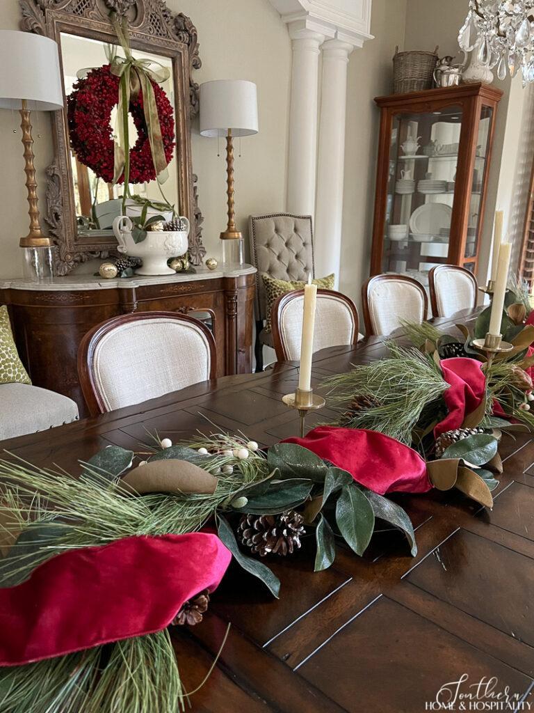 Magnolia and pine garland with red velvet ribbon dining table decor