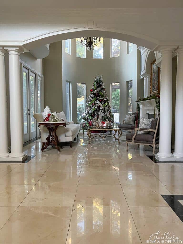 Christmas tree in living room with arch entry and columns