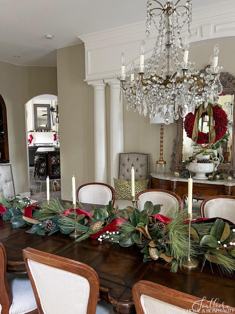 Dining table decorated with magnolia and pine Christmas garland