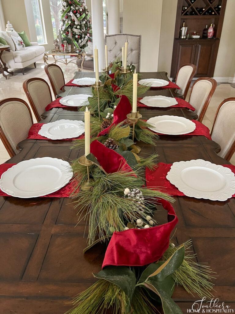 White chargers on red napkin place settings