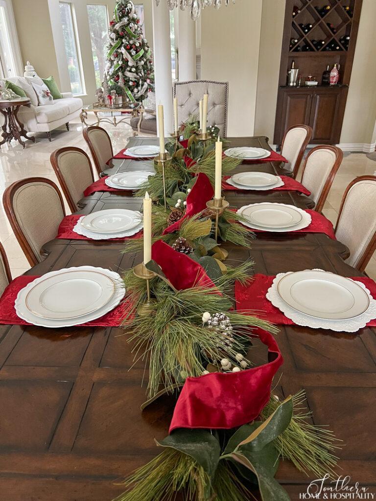 White china and red napkins on Christmas dinner table