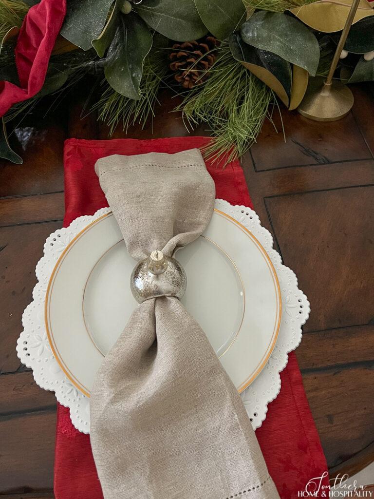 Linen napkin in a Christmas ornament napkin ring