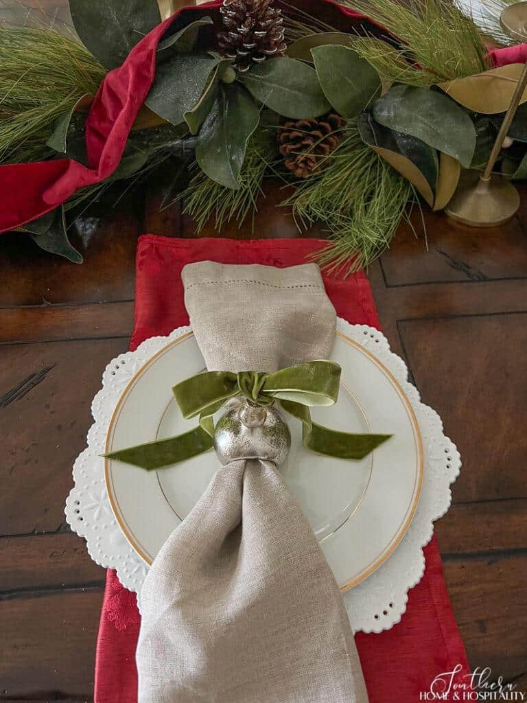 Red and green Christmas place setting with velvet ribbon