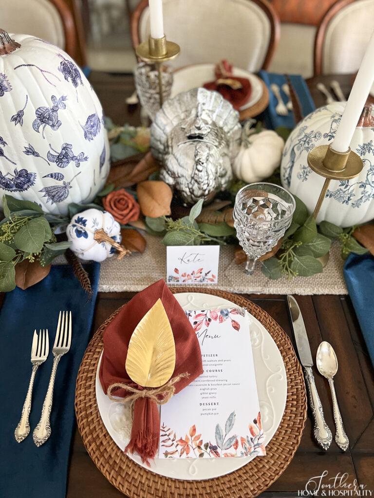Thanksgiving place setting with blue and rust decor and printable place cards and menu