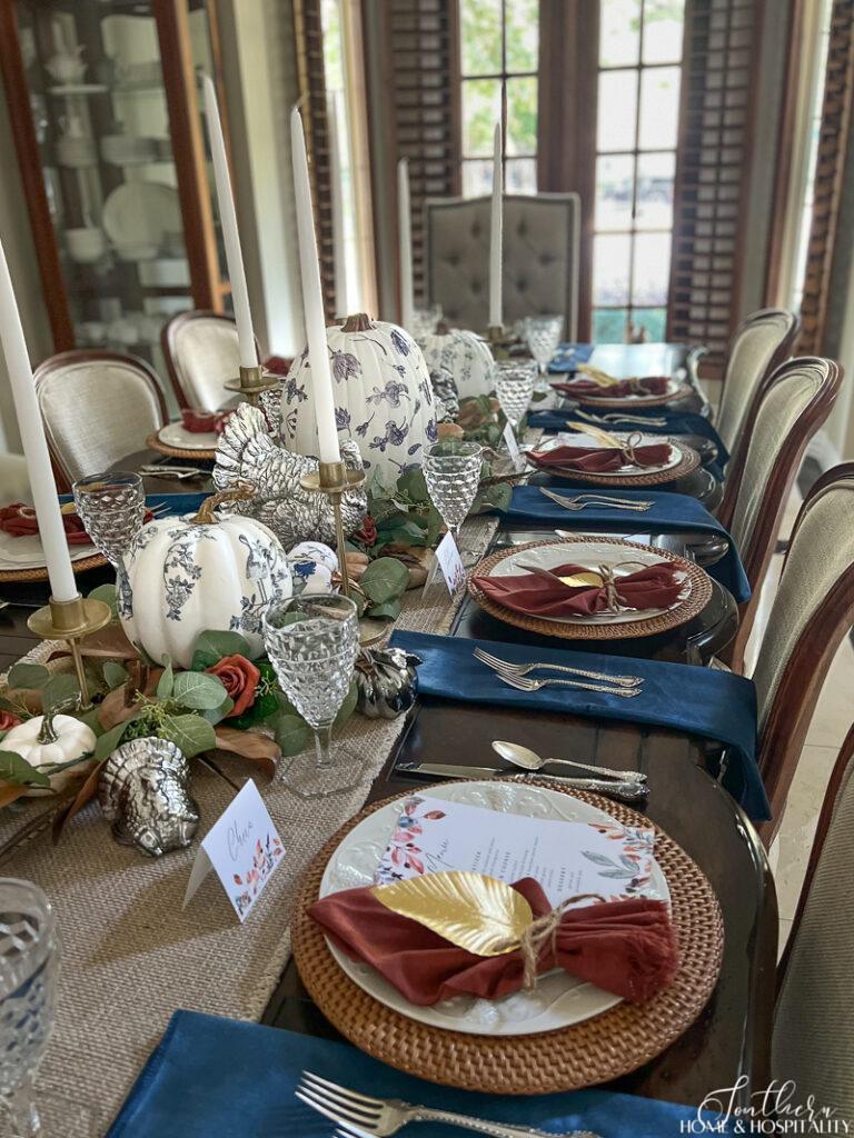 Thanksgiving tablescape with blue and rust and printable place cards and menu
