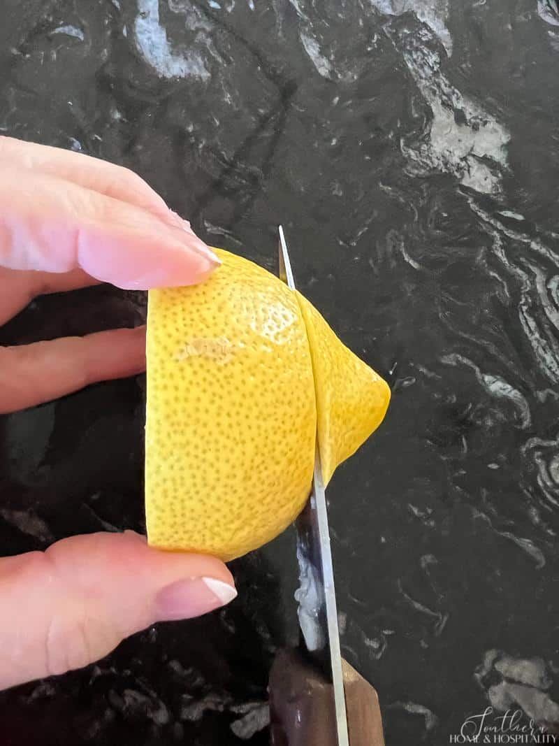 Cutting a lemon to make lemon twists