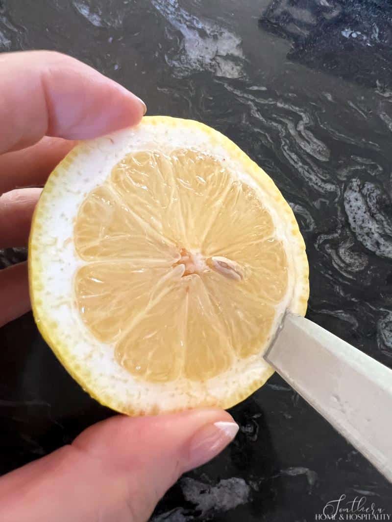 Cutting the peel off of lemon
