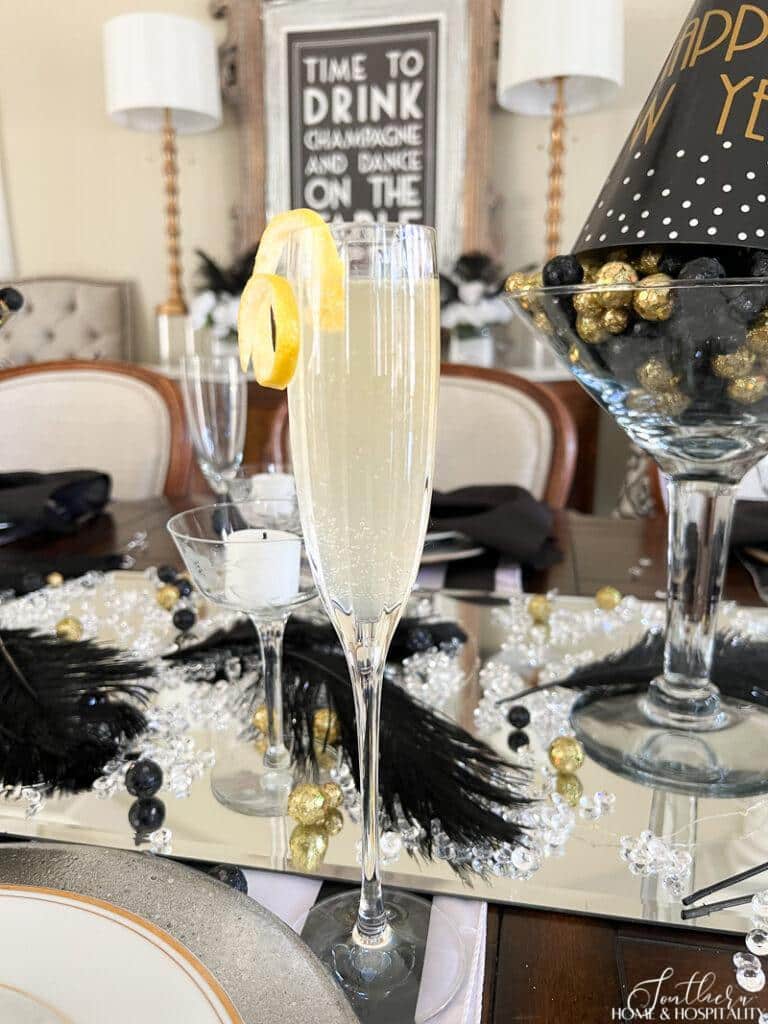 French 75 cocktail in champagne flute with lemon twist