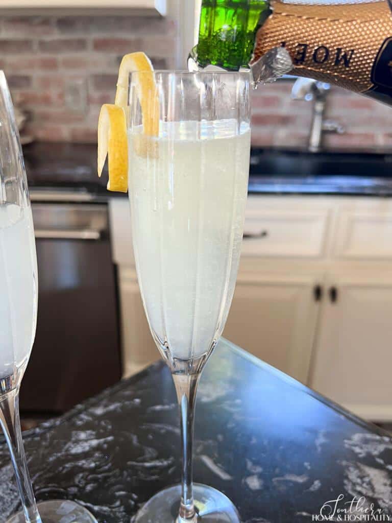 pouring champagne into French 75
