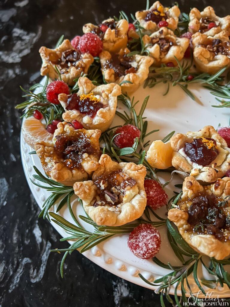 Goat cheese tartlets with fig jam, cranberry, and raspberry chipotle sauce