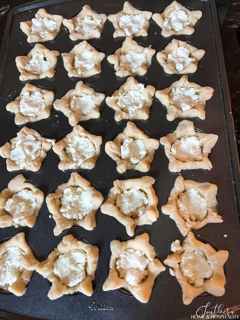 Unbaked pie tarts filled with goat cheese