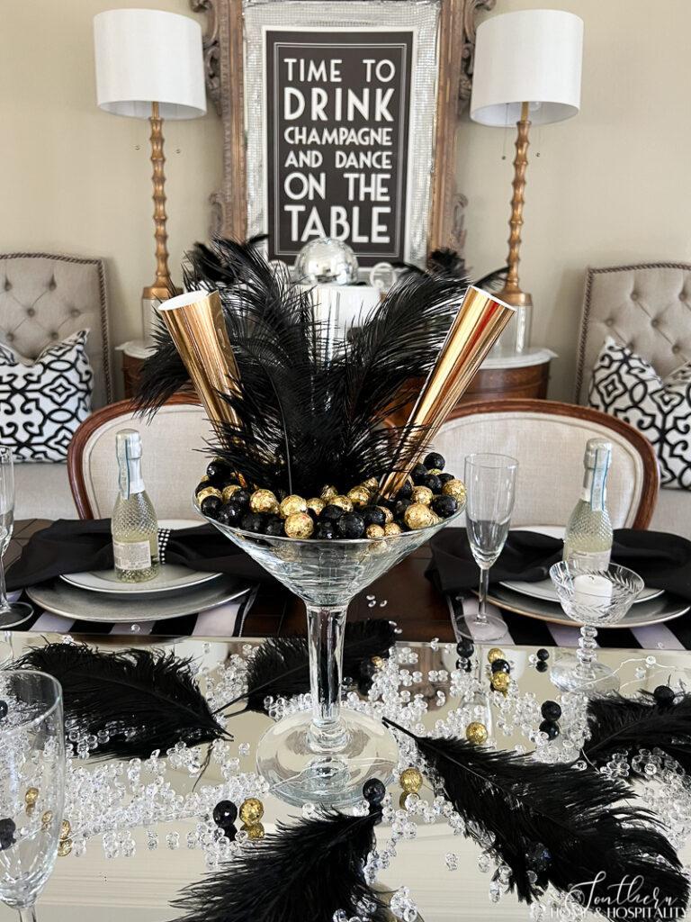 Jumbo martini glass centerpiece with party horns and feathers