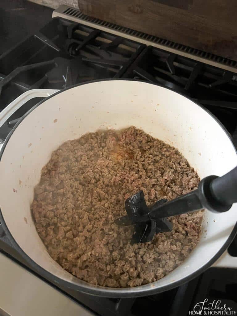 Browning sausage in an enamel cast iron pan