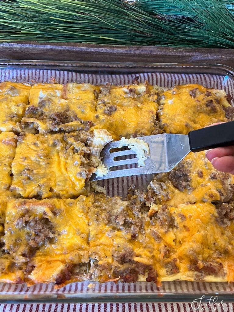 Sausage, egg, and cheese breakfast casserole cut into squares in the pan