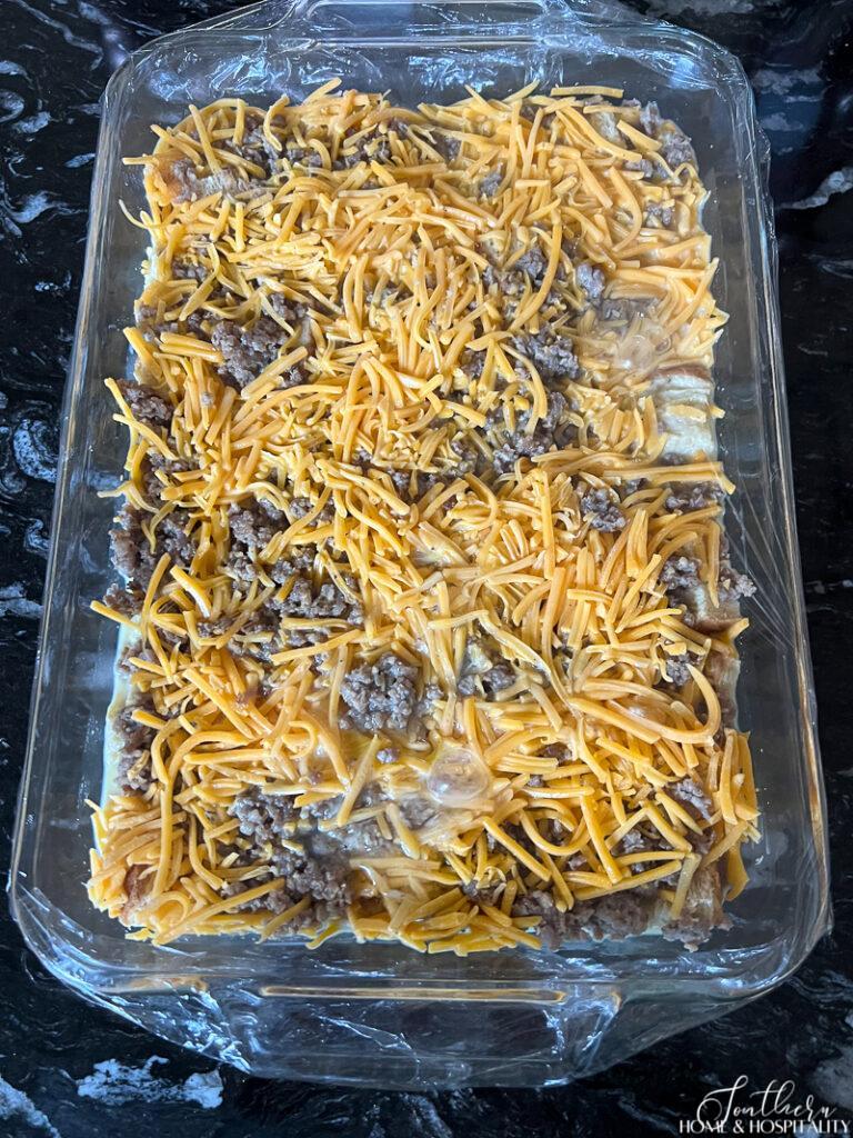 Unbaked casserole covered with plastic wrap