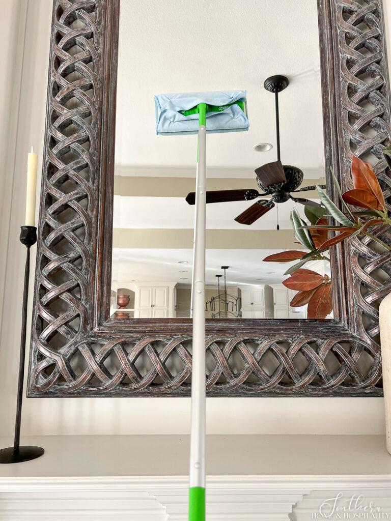 Cleaning mirror with a Swiffer mop and glass microfiber rag