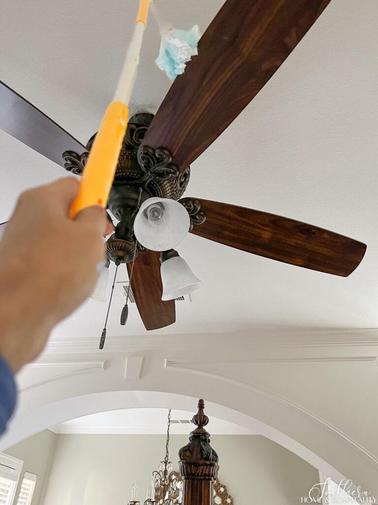 Cleaning ceiling fan with Swiffer duster