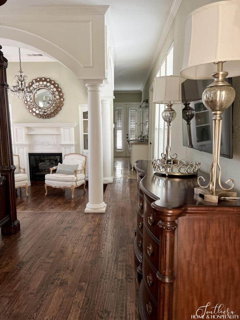 Arch architectural feature and columns in bedroom, bedroom open to bathroom