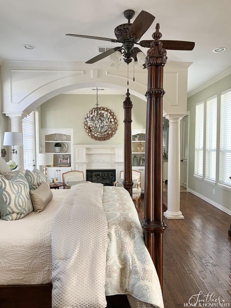 Traditional primary bedroom with calming green walls and spa blue bedding