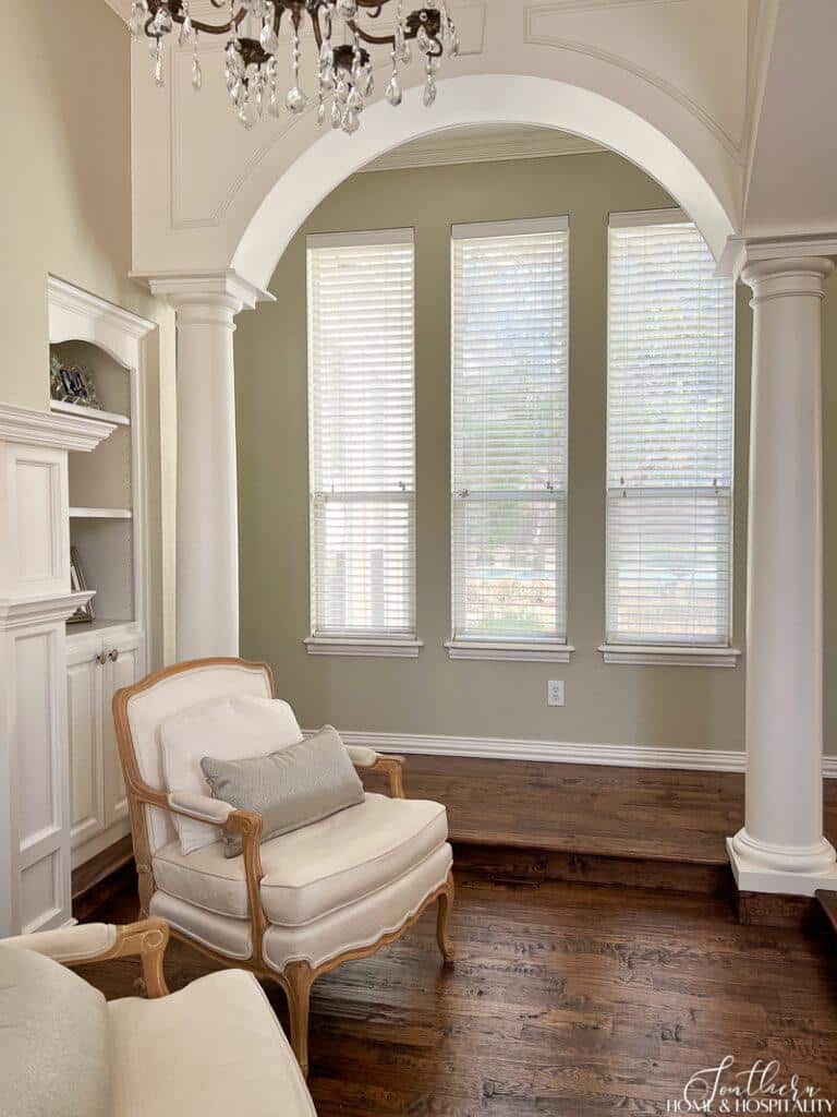 Sunken bedroom sitting area with wood arches and columns