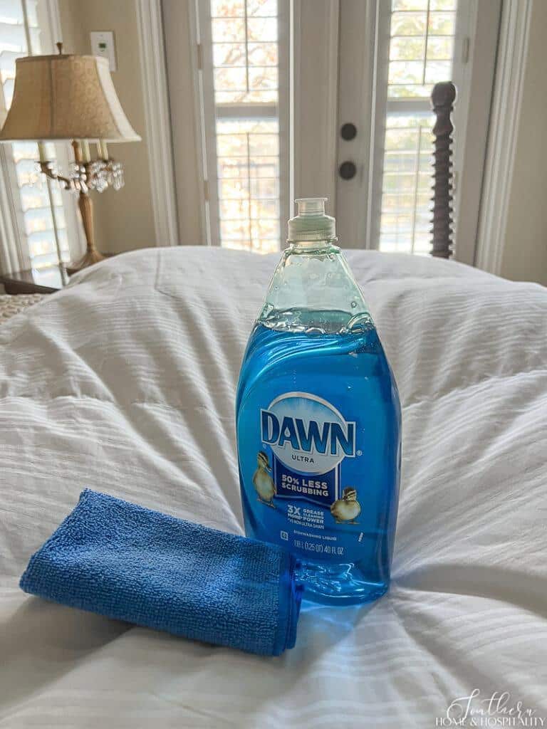 Dawn dish soap sitting on comforter