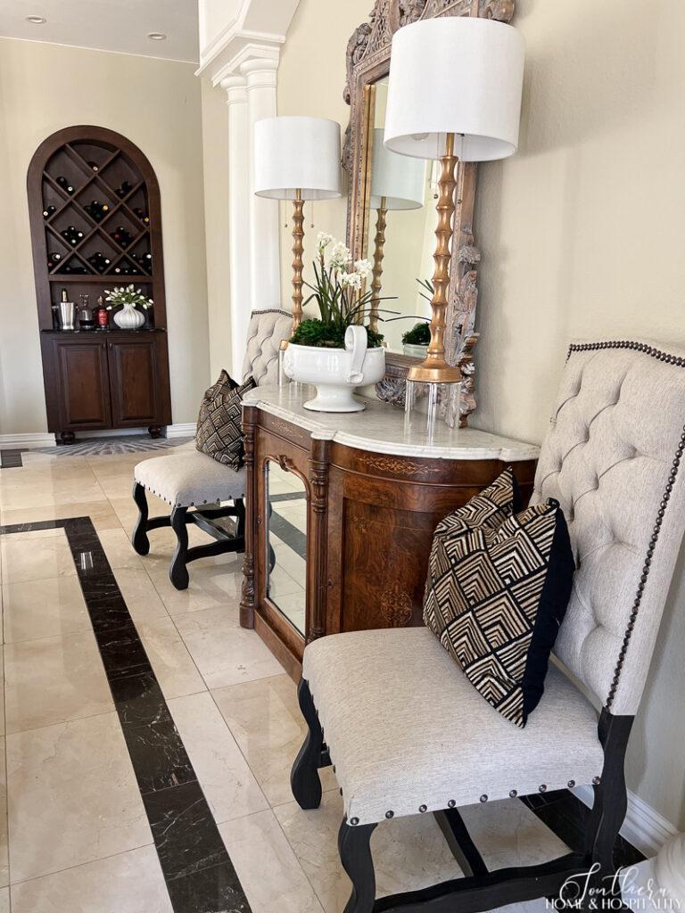 Vintage marble top sideboard in dining room with neutral colors