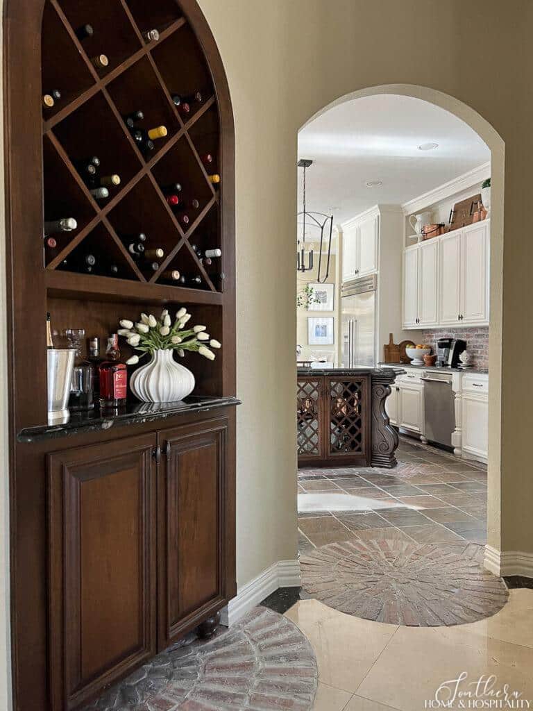 Wine bar in dining room and arch entry into kitchen