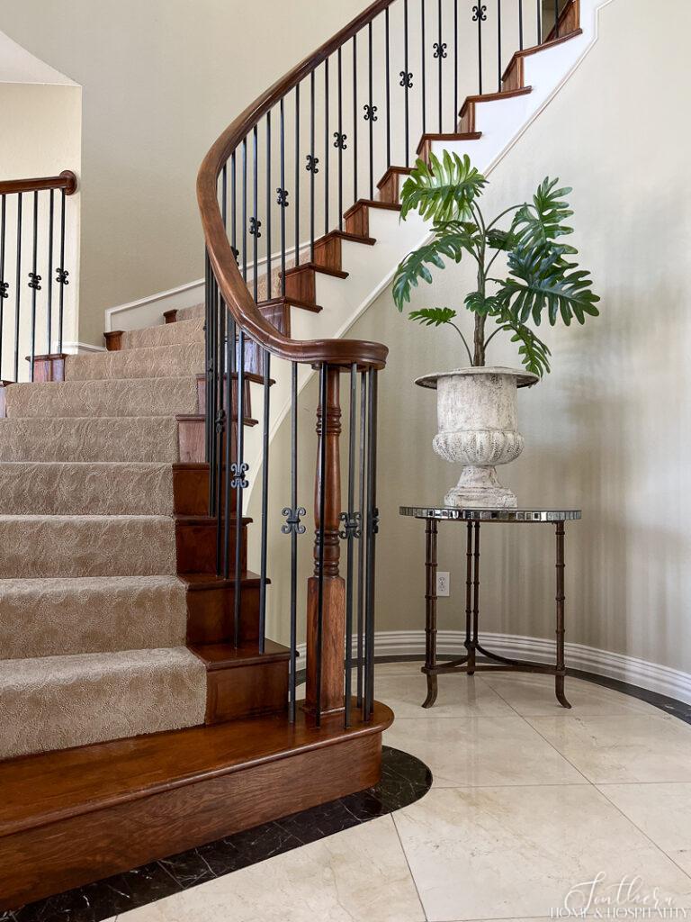 Green plant in urn in foyer by staircase