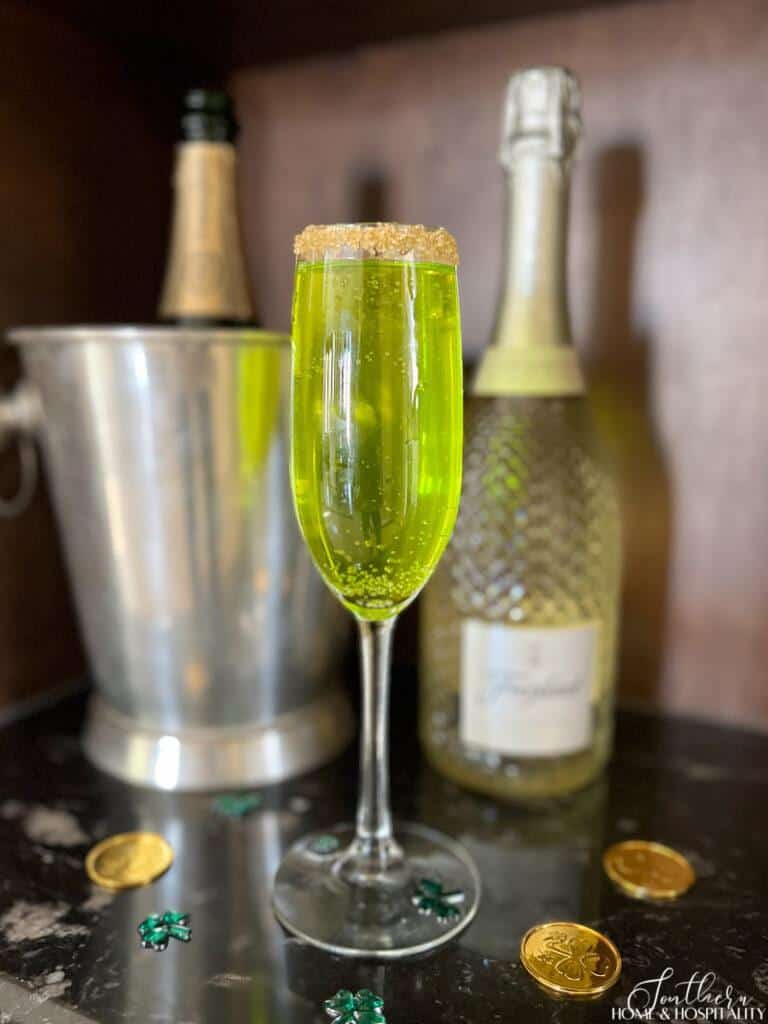 Green prosecco drink with gold sugar rim