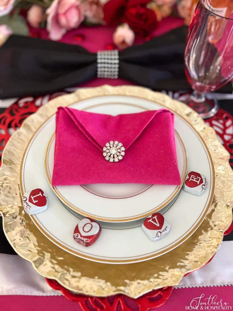 Envelope napkin with diamond clasp on Galentine's Day table