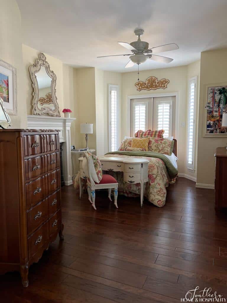 French style girls bedroom with wood floors and fireplace