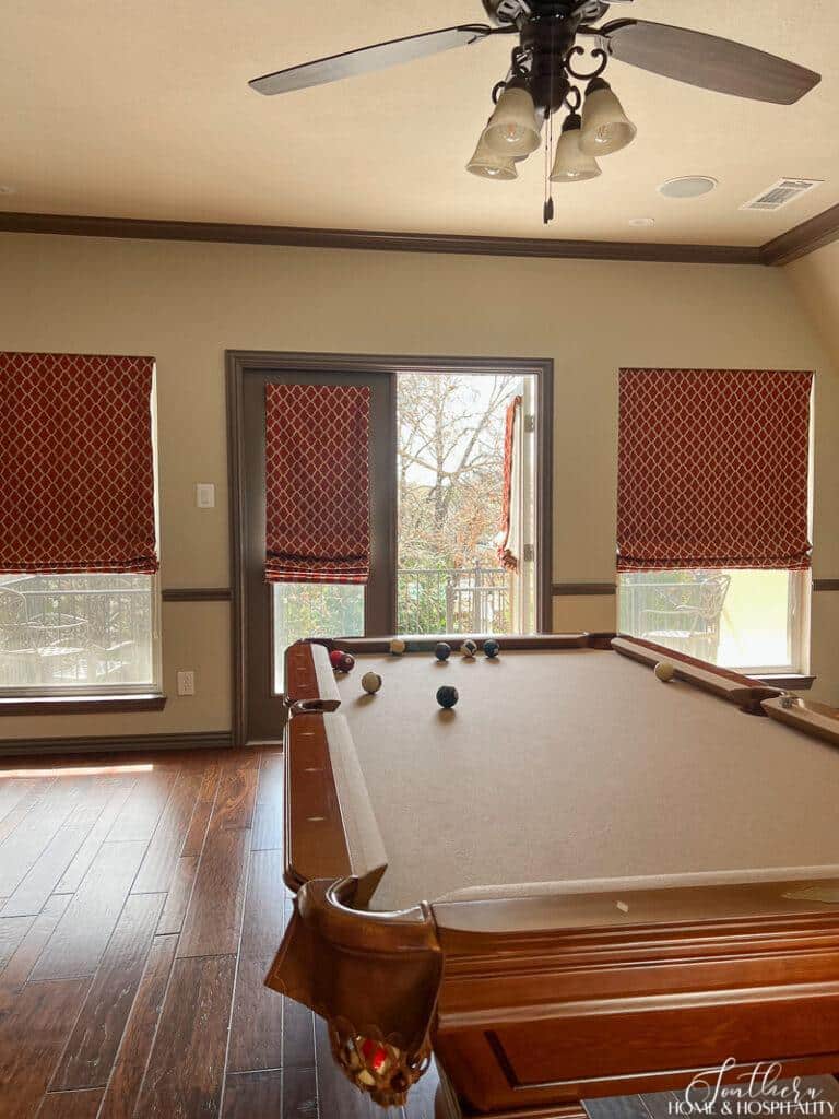Game room with French doors and red shades