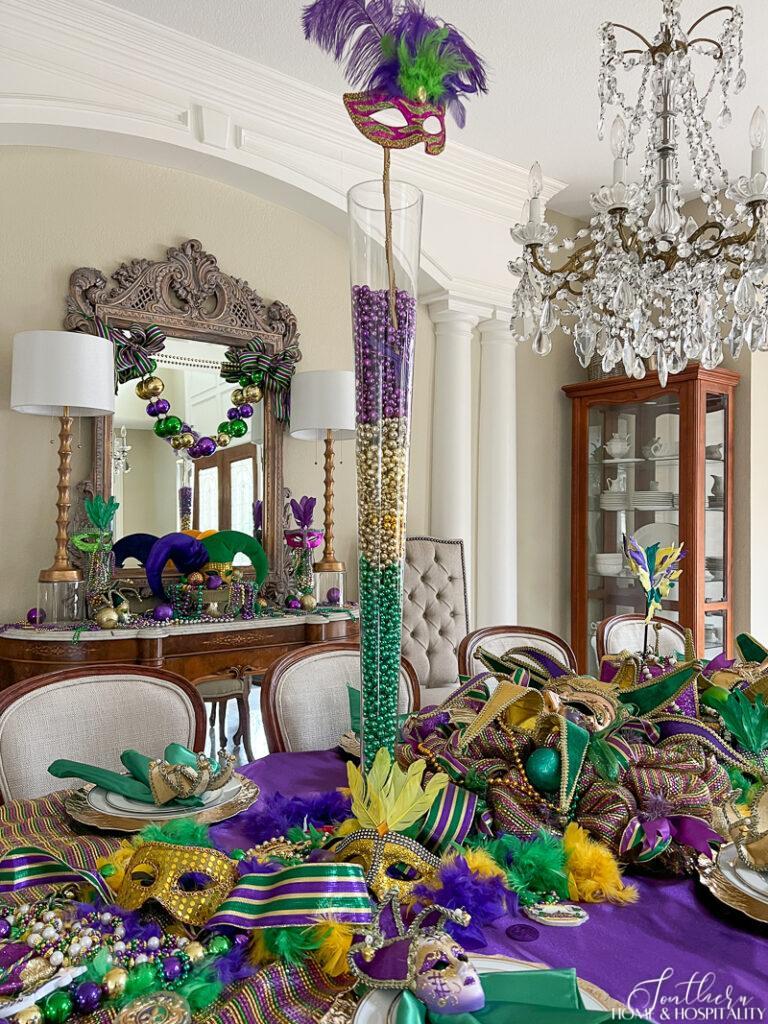 Tall pilsner vase filled with Mardi Gras beads and a mask