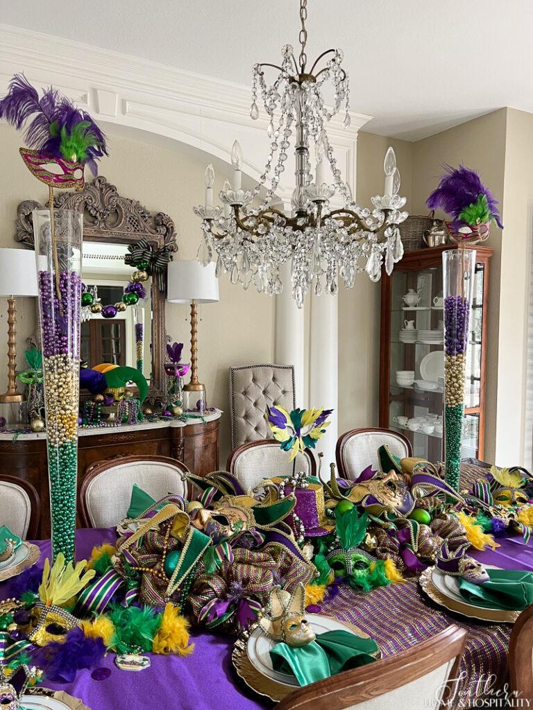Mardi Gras dining table decor with tall glass vases