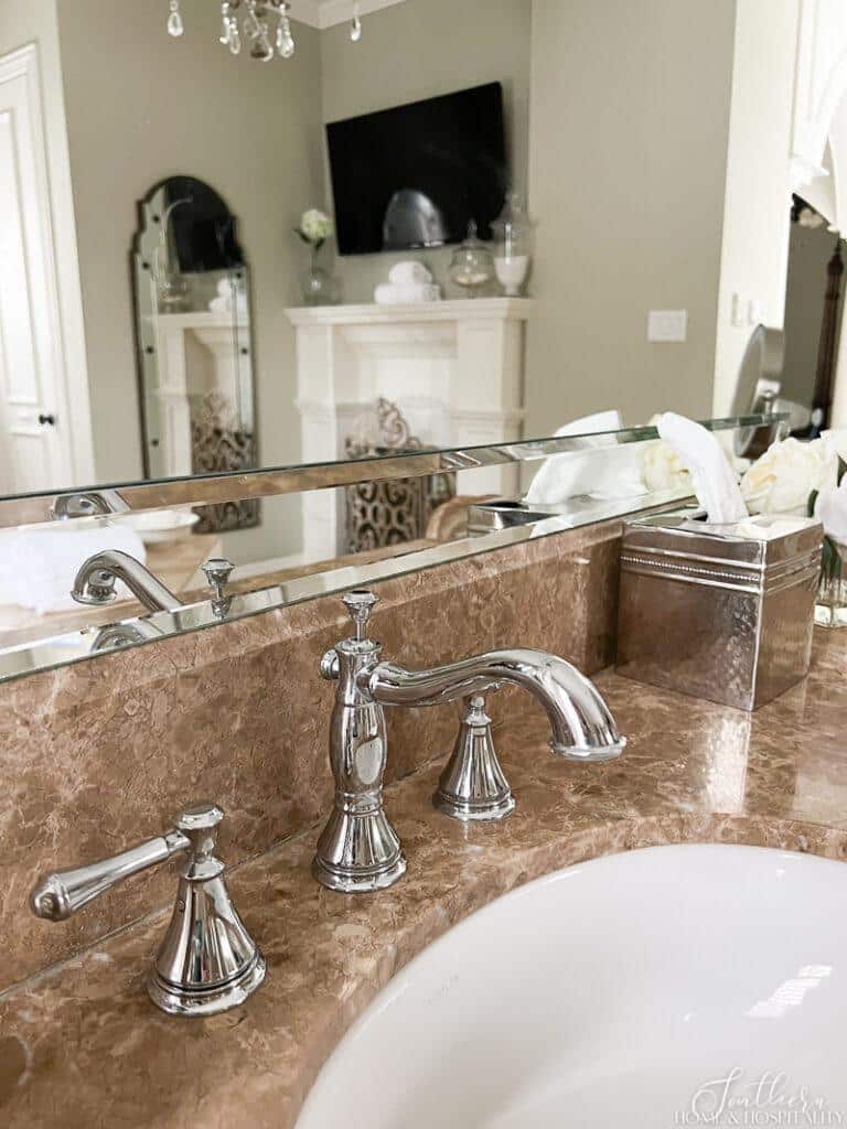 Delta Cassidy widespread bathroom sink faucet and tan marble bathroom counter