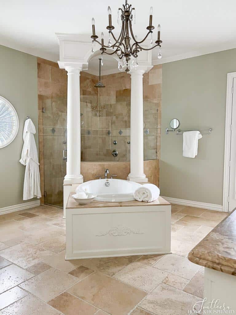 French style primary bathroom with travertine tile