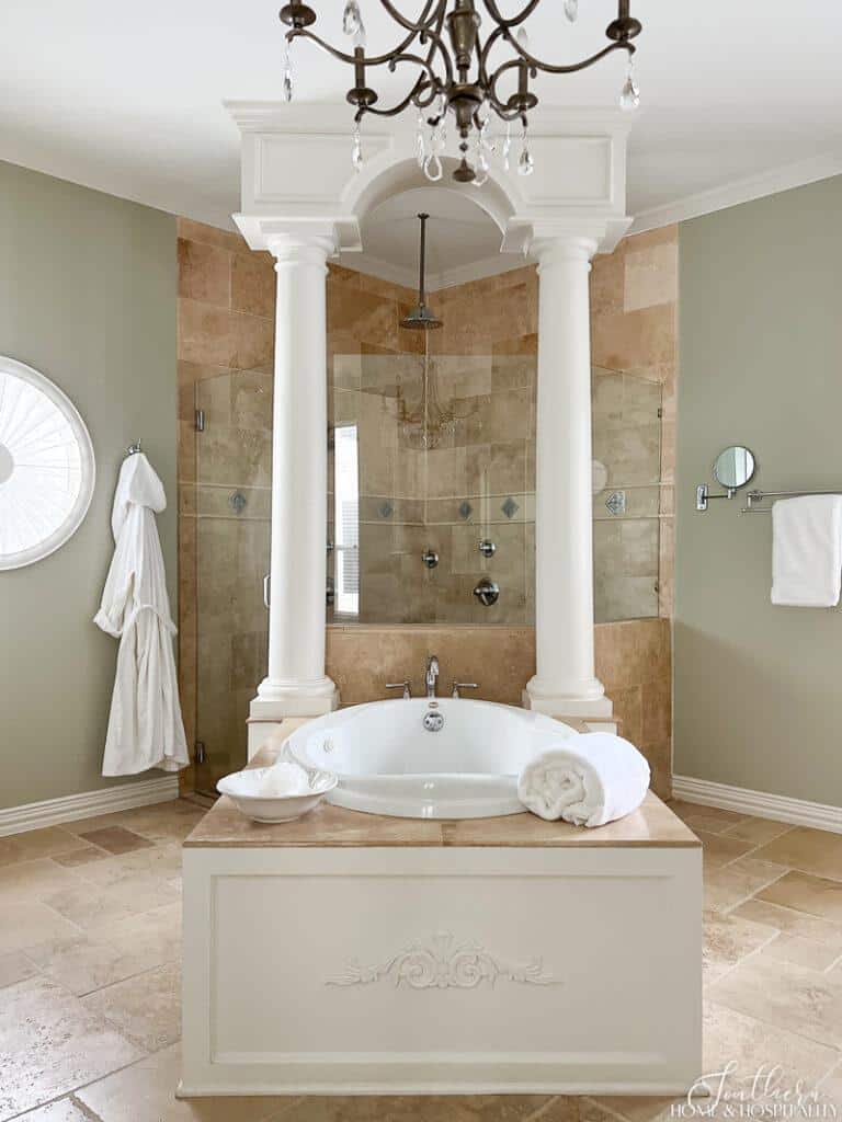 Timeless Master Bathroom Makeover with tub with wood panel surround and travertine shower