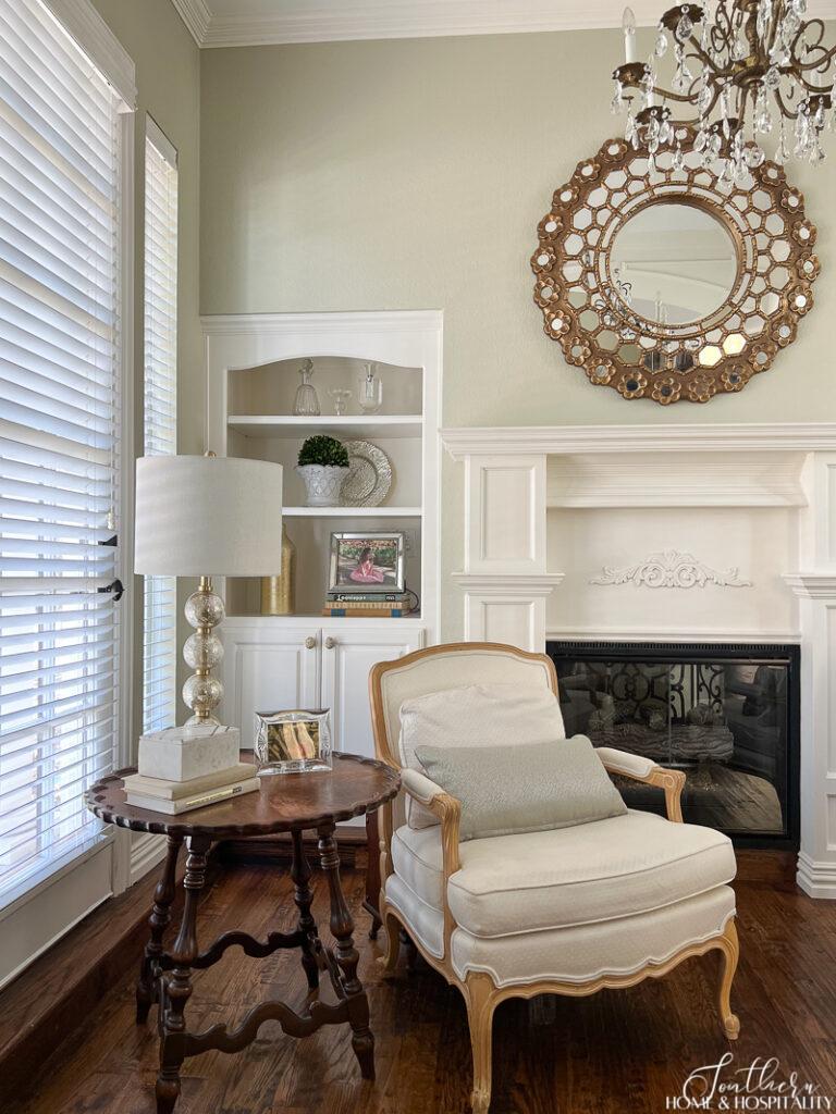 French chair and vintage scalloped table in bedroom sitting area