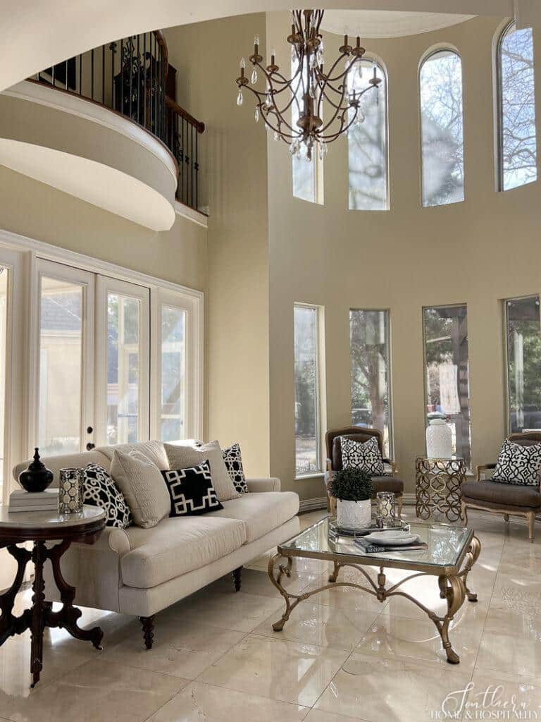 Two story traditional living room with black and ivory color scheme