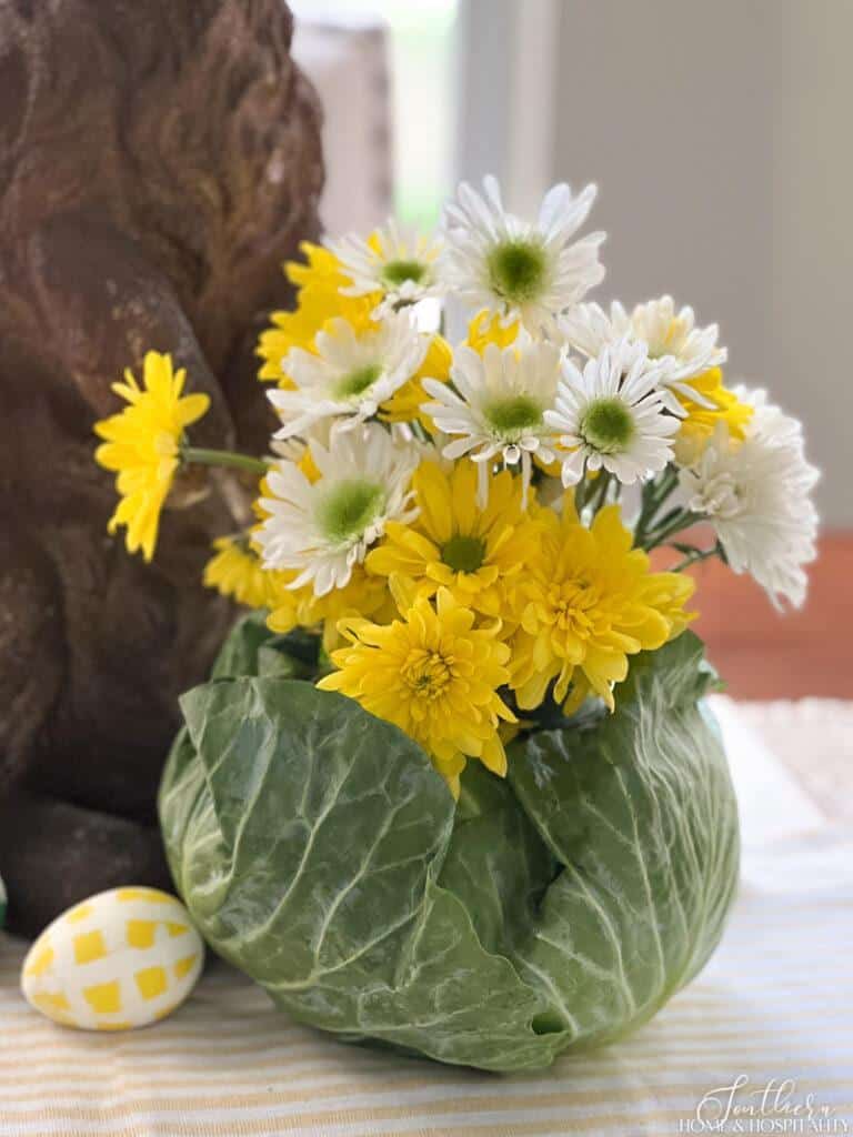 DIY cabbage vase arrangement with yellow and white flowers