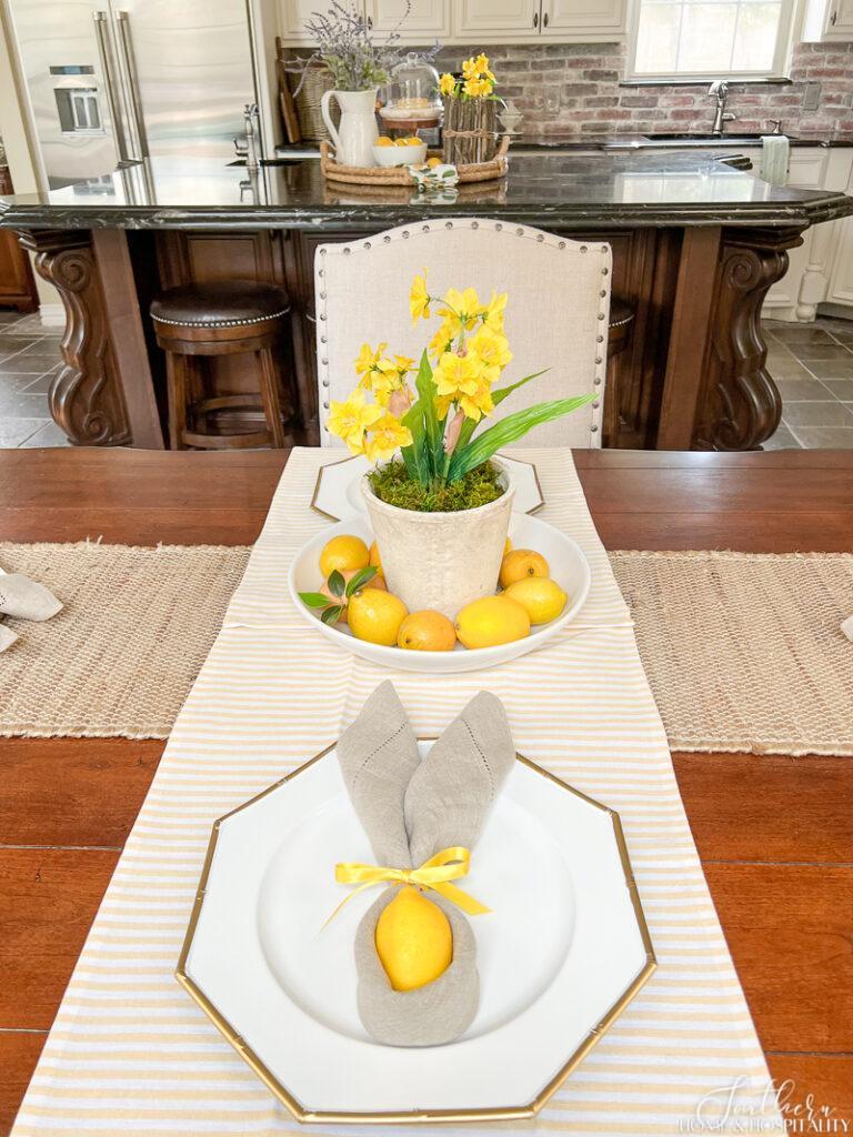 Spring table decor with yellow and white stripe table runner