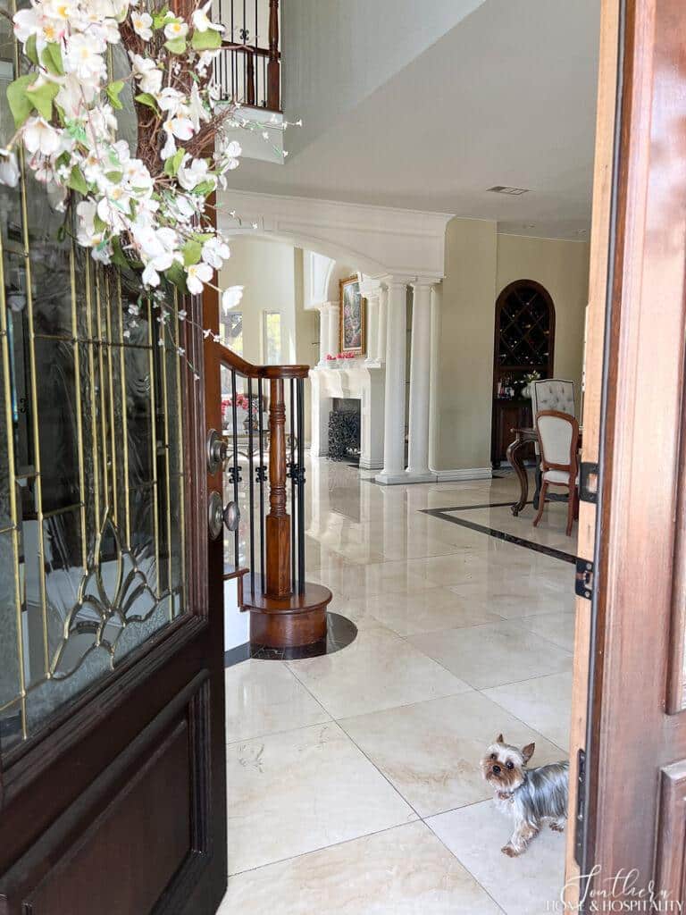 Open door to house tour with yorkie greeter