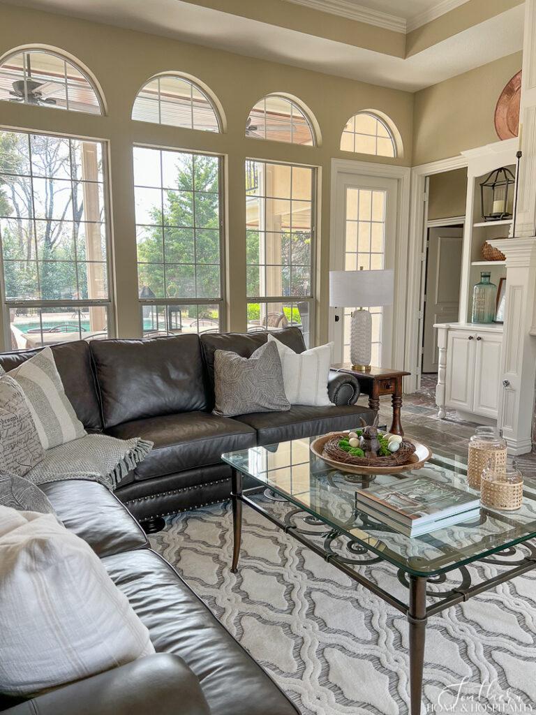 Neutral family room with leather sofa and spring decor