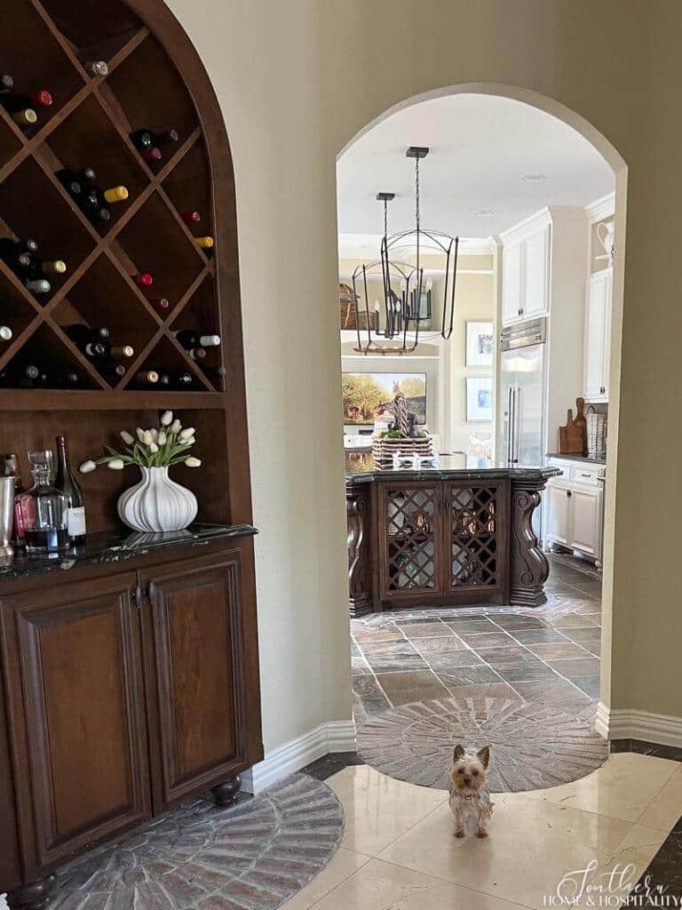 Wine bar with spring tulips and curved arch entry into kitchen