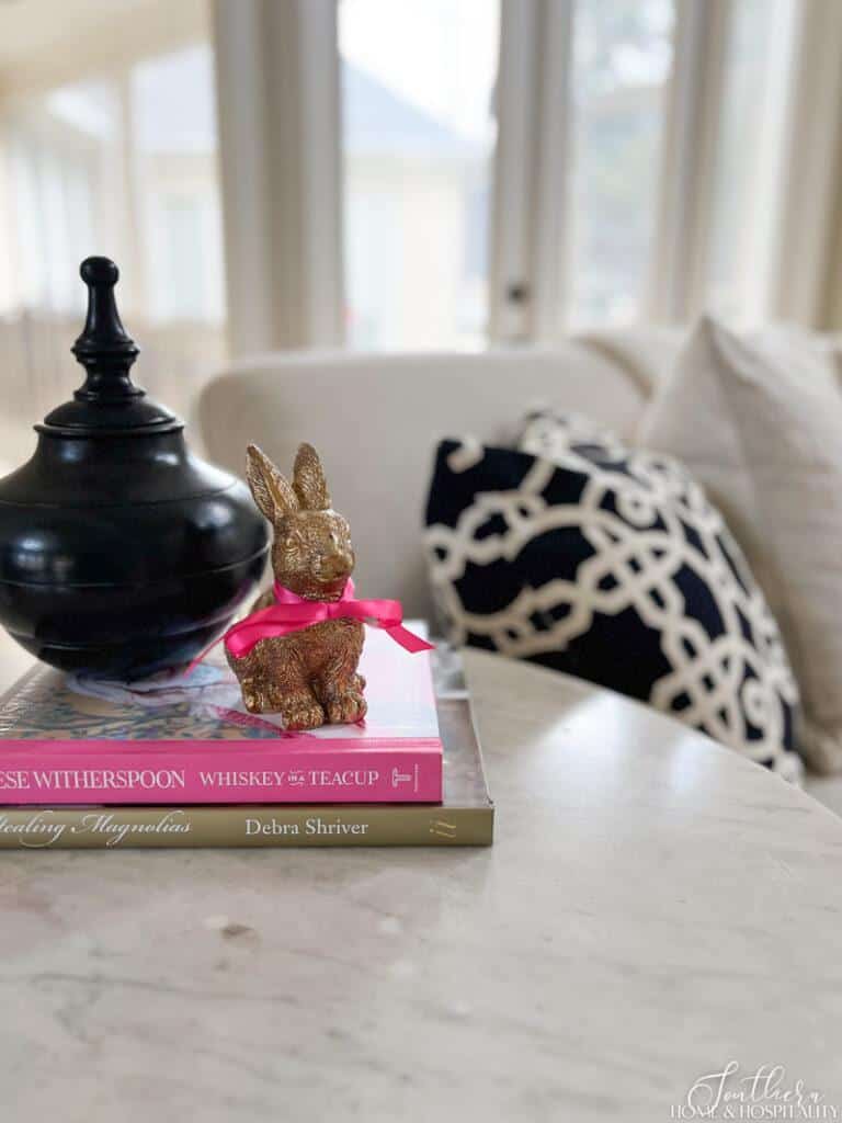 Gold rabbit statue with pink bow in end table Easter vignette