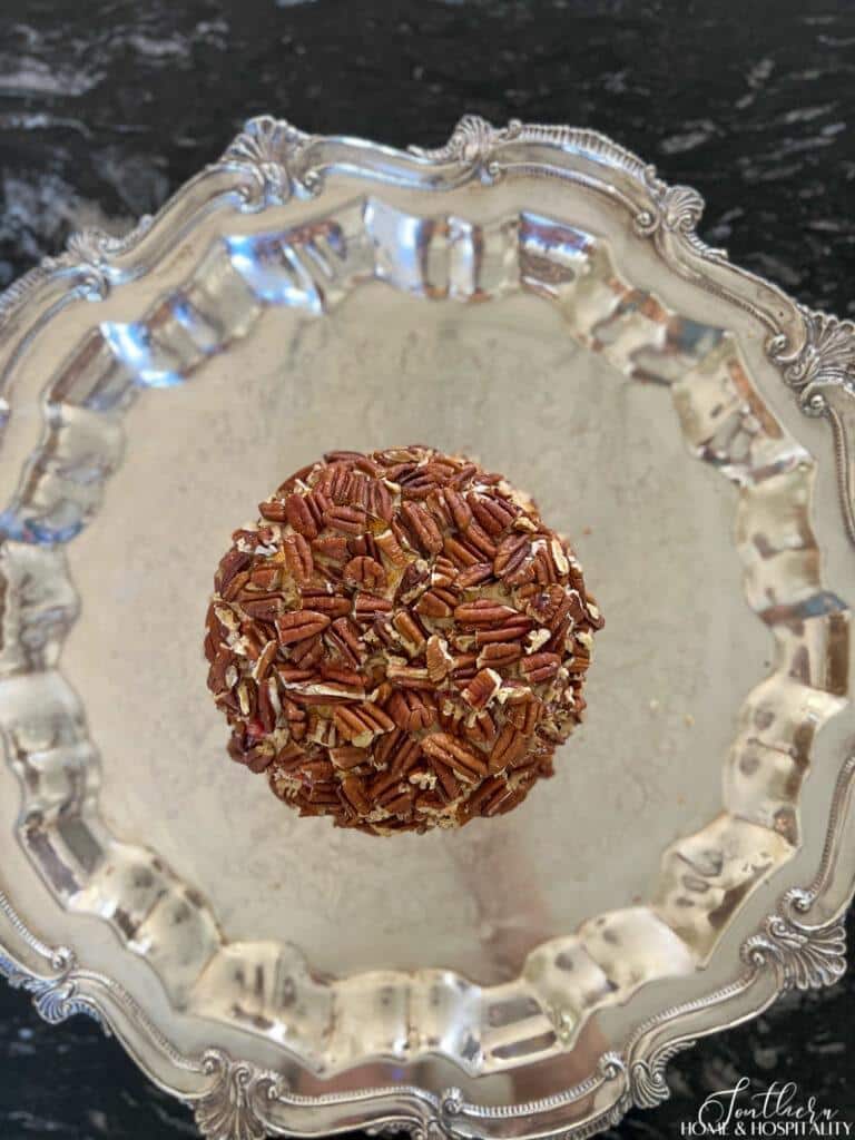 Pecan coated pimiento cheese ball on silver platter